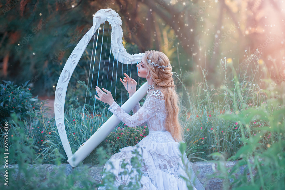 Foto de mysterious forest nymph plays on white harp in fabulous place, girl  with long blond hair and elegant lace vintage dress calling for bright sun  rays, lady with silver jewelry and