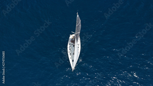 Aerial photo of sail boat cruising open ocean deep blue sea © aerial-drone