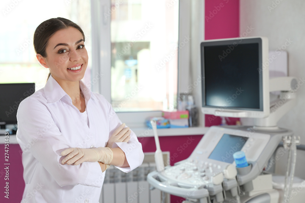 Sonographer near modern ultrasound machine in clinic, space for text Sonographer near modern ultrasound machine in clinic, space for text
