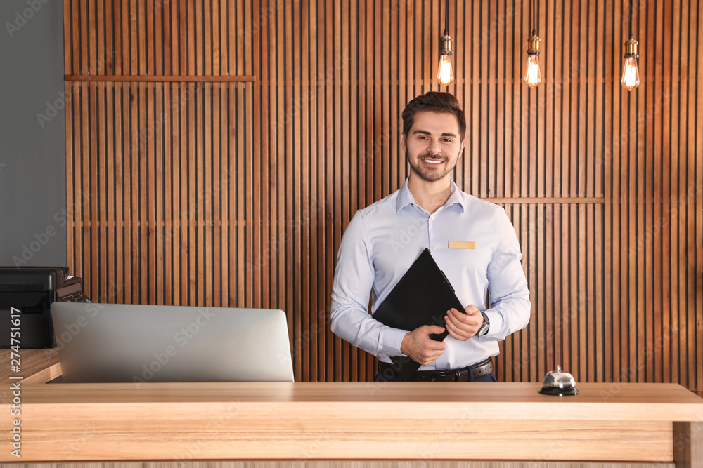 Portrait of receptionist with clipboard at desk in lobby Stock 写真