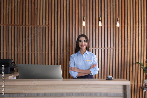 Canvas Print Portrait of receptionist at desk in lobby