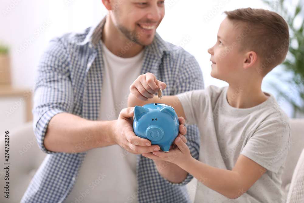 Family with piggy bank and money at home Family with piggy bank and money at home
