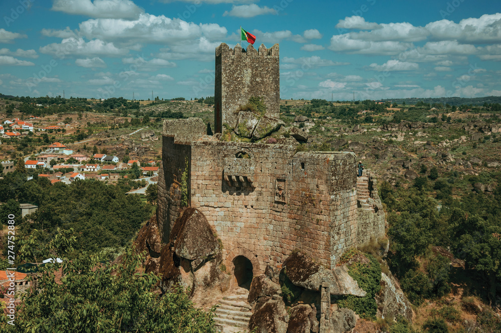 Fototapeta premium Stone castle and tower over rocky cliff