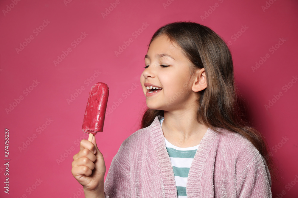 Adorable little girl with delicious ice cream against color background Adorable little girl with delicious ice cream against color background