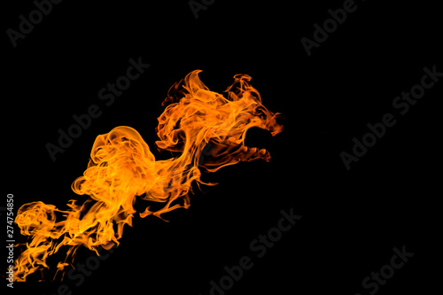 Fire in the form of the mouth of an animal or a dragon. Fire flames on black background. fire on black background isolated. fire patterns.