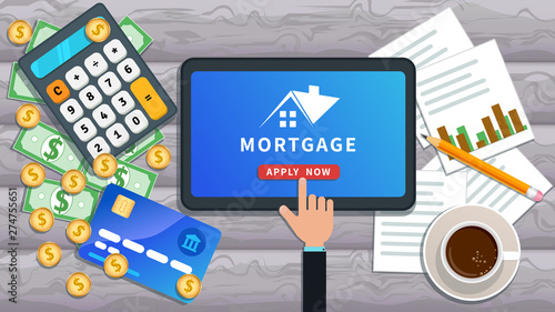 Mortgage loan online. Buy real estate, home mortgage. Flat tablet with house logo and hand clicking apply now button on desk with credit card, calculator, cash, cup of coffee, paper chart and pencil