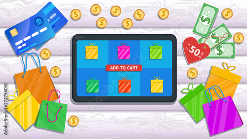 Online shopping, store with mobile app. Flat tablet with price tag, gift boxes icon and add to cart button on screen isolated on wooden desk with credit cards, shopping bags, heap of cash and coins