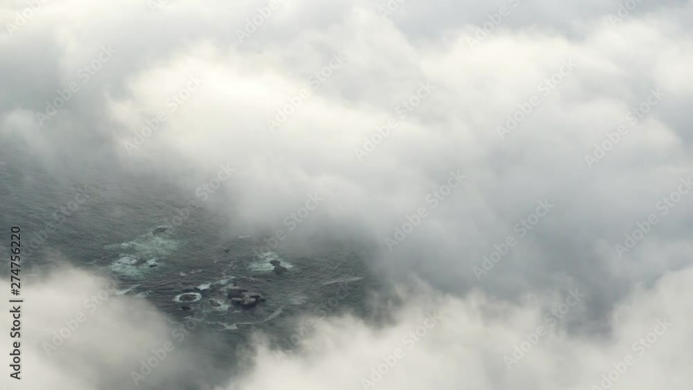 Moving clouds above the ocean with beatiful coastline captured from above in Cape Town South Africa Moving clouds above the ocean with beatiful coastline captured from above in Cape Town South Africa