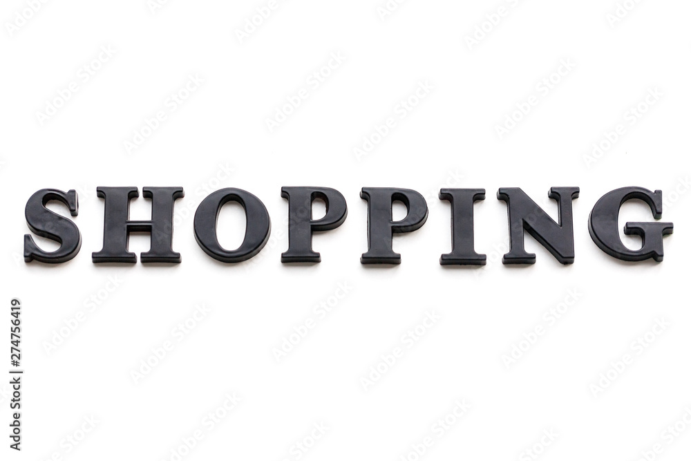 The inscription SHOPPING. SHOPPING in black bulk letters on a white background. Photo of the lettering, close-up