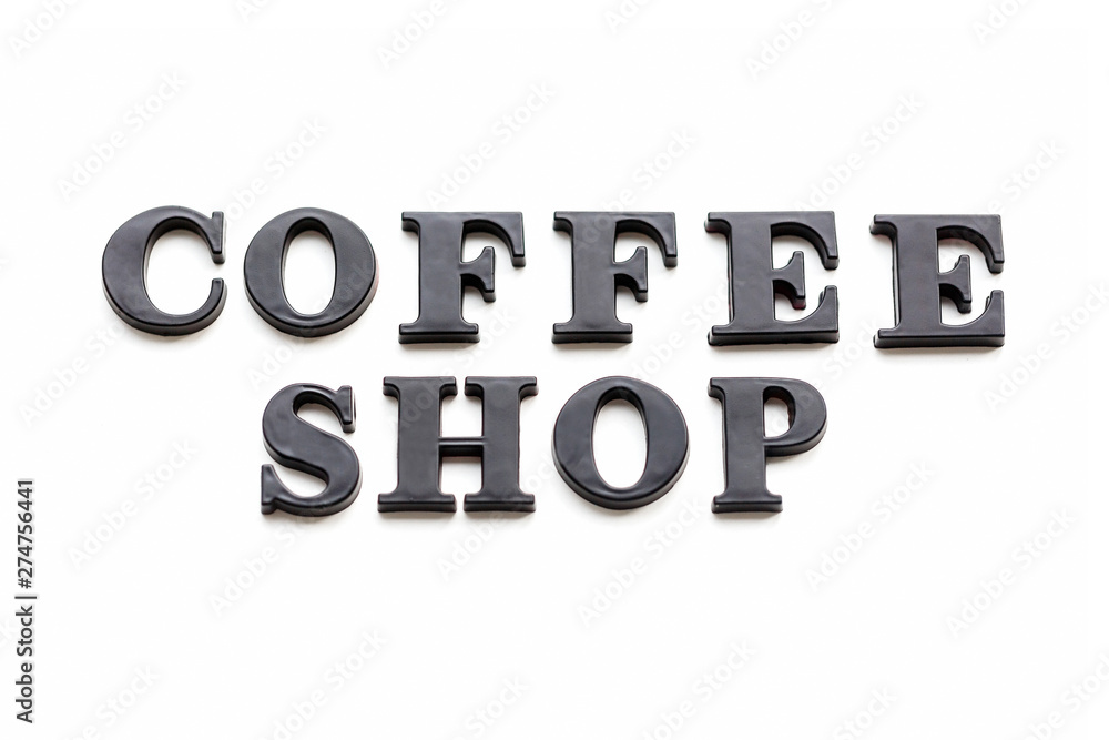 The inscription COFFEESHOP. COFFEESHOP in black bulk letters on a white background. Photo of the lettering, close-up The inscription COFFEESHOP. COFFEESHOP in black bulk letters on a white background. Photo of the lettering, close-up