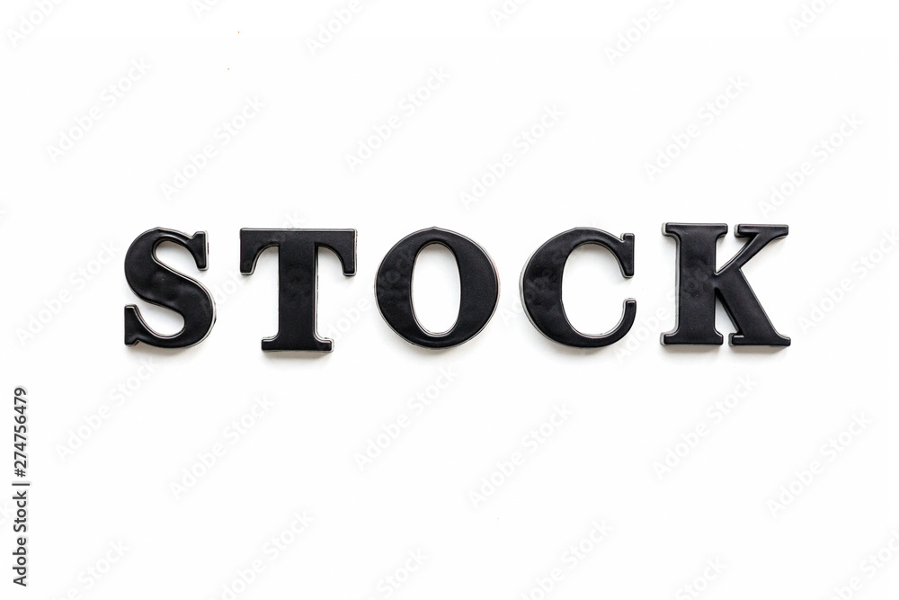The inscription STOCK. STOCK in black bulk letters on a white background. Photo of the lettering, close-up The inscription STOCK. STOCK in black bulk letters on a white background. Photo of the lettering, close-up