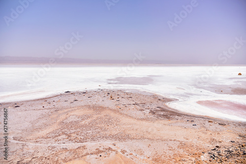 DEGUECHE, TN - JULY, 2019: Chott el Djerid, also spelled Sciott Gerid and Shott el Jerid, is a large endorheic salt lake in southern Tunisia.  photo
