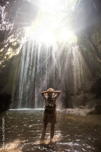 Fototapeta Naklejka Na Ścianę i Meble -  Woman near waterfal on Bali, Indonesia 
