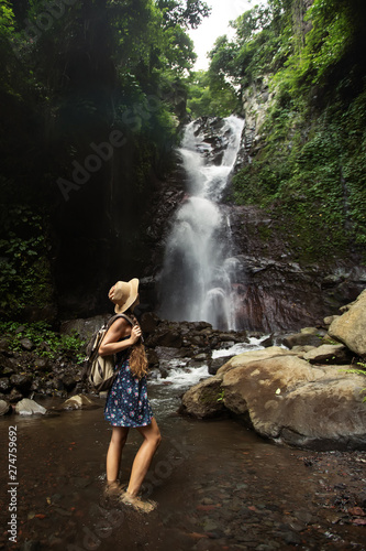 Fototapeta Naklejka Na Ścianę i Meble -  Woman near waterfal on Bali, Indonesia 