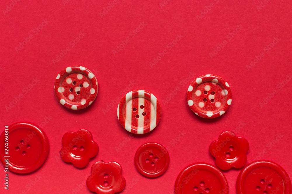 Various red sewing buttons on red background Various red sewing buttons on red background