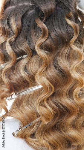 Silver hairdressers clips in curly hair