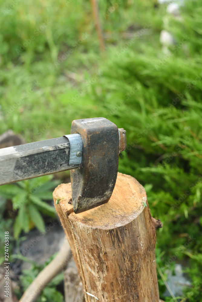The process of cutting wood with a cleaver. Axe in the log The process of cutting wood with a cleaver. Axe in the log