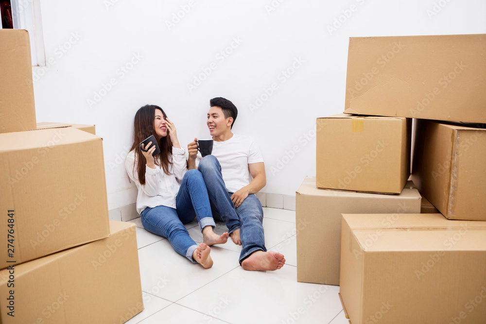 Happy couple drinks hot coffee in the new house Happy couple drinks hot coffee in the new house
