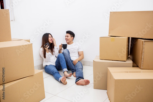 Happy couple drinks hot coffee in the new house © Creativa Images
