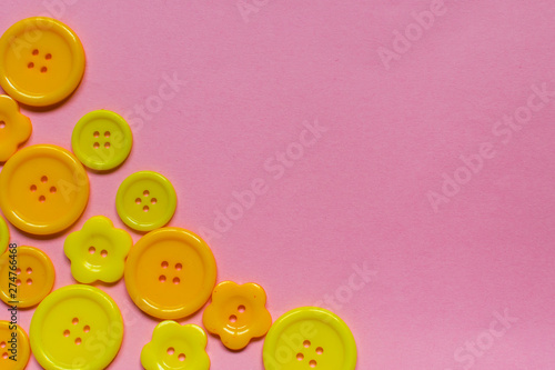 various yellow buttons on light pink background