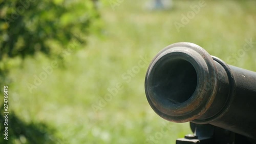 realistic cossak's cannon is being shot on the retro Ukrainian festival otdoors, Close up 