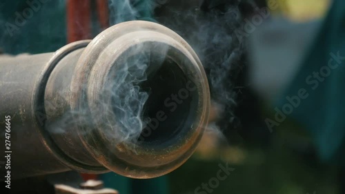 realistic cossak's cannon is being shot on the retro Ukrainian festival otdoors, Close up 