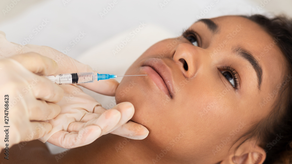 Lip Augmentation. Afro Woman Receiving Hyaluronic Acid Injection