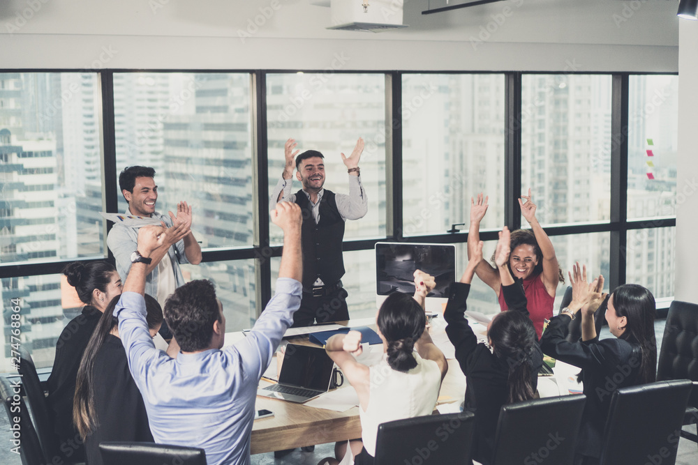 Business team celebrating a triumph with arms up Business team celebrating a triumph with arms up