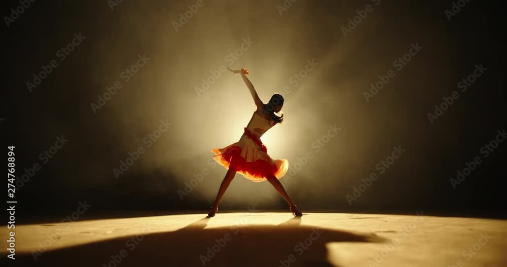 Talented asian female teenager is performing ballroom sport dance on