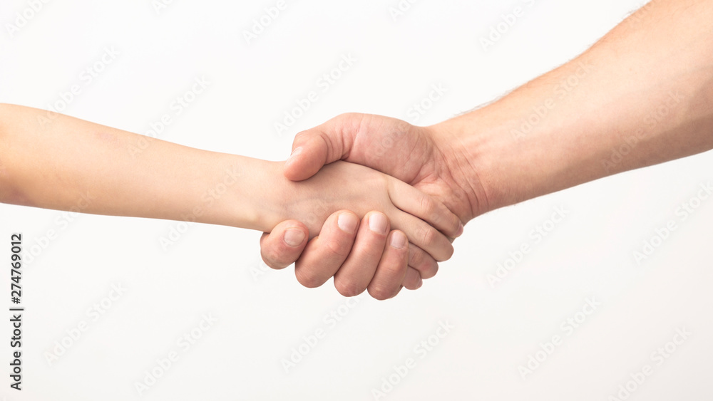 Agreement between parent and kid. Handshake of father and daughter Agreement between parent and kid. Handshake of father and daughter