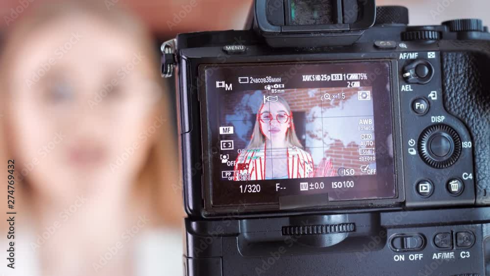 Close-up screen of professional camera during recording video of young beautiful female blogger Close-up screen of professional camera during recording video of young beautiful female blogger