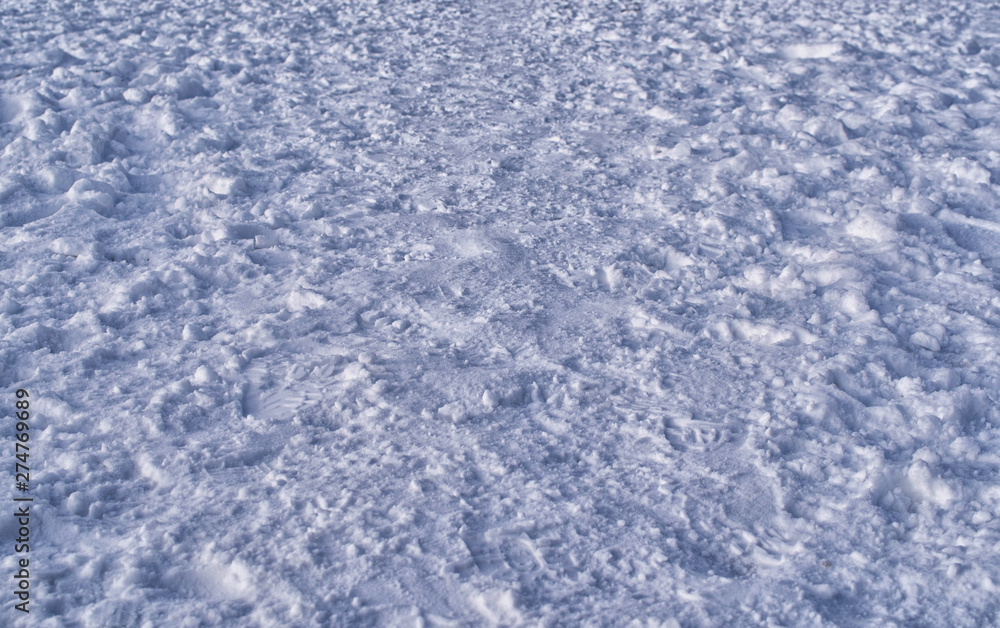 numerous footprints in the snow create a winter background numerous footprints in the snow create a winter background