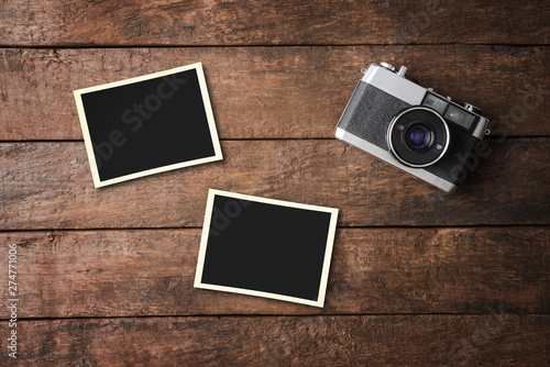 Vintage camera with empty photo frames. Top view