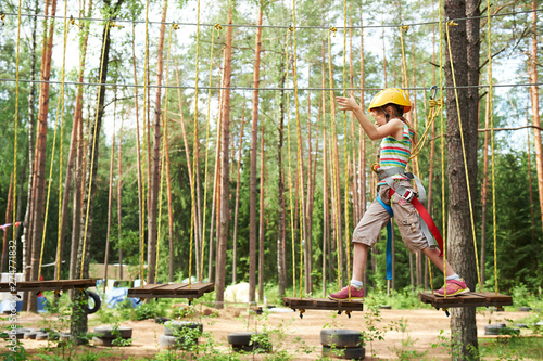 Canvas Print girl at climbing activity in high wire forest park