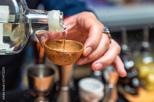 Barman serving tequila in an artisan glass