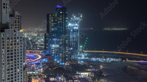 Wallpaper Mural Waterfront overview Jumeirah Beach Residence JBR skyline aerial night timelapse with illuminated skyscrapers. Shops, restaurants and other entertainment from above with traffic Torontodigital.ca