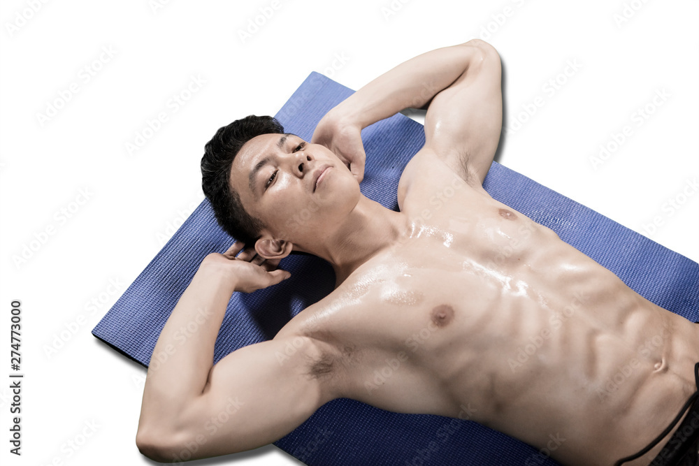 Shirtless man doing crunches exercises on studio Shirtless man doing crunches exercises on studio