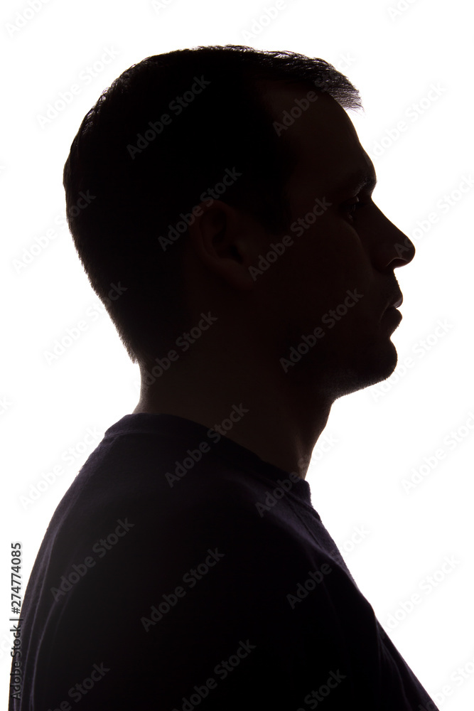 Portrait of a young man, side view - dark isolated silhouette Portrait of a young man, side view - dark isolated silhouette