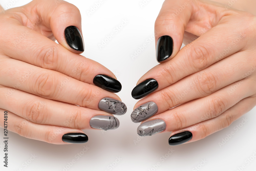 black-gray manicure with a cobweb on short oval nails with stones on a white background black-gray manicure with a cobweb on short oval nails with stones on a white background