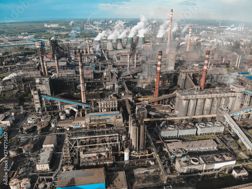 Large industrial zone of heavy metallurgical industry aerial view, lot of factories with pipes, smokestacks and smoke © DedMityay