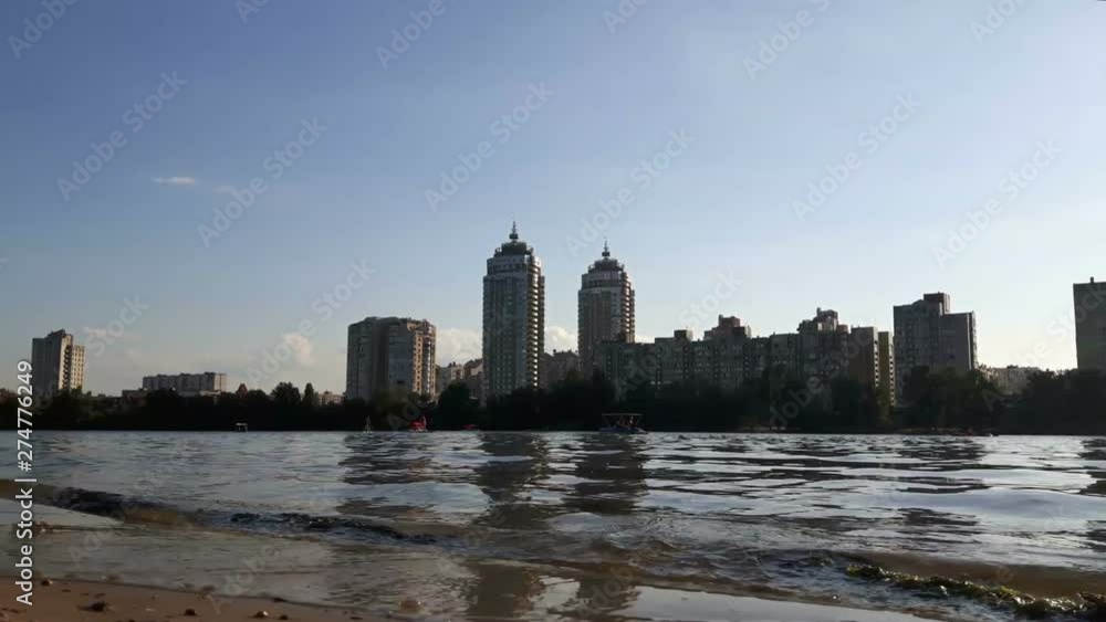 View of the river with sailing catamarans and boats.View of the river and the city on the horizon.