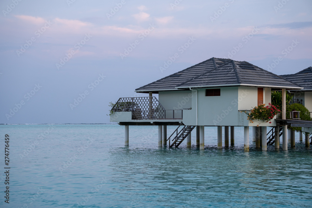 beautiful isolated luxury water bungalows Maldives in the blue green ocean of the maldives