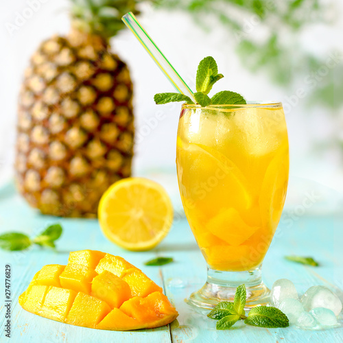 Yellow iced tea with pineapple, lemon