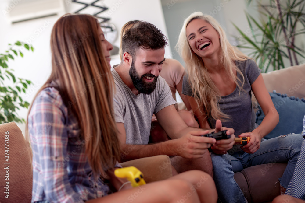 Friends playing video games at home Friends playing video games at home