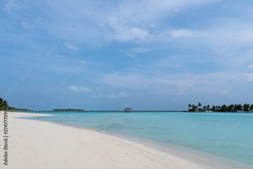 Wide sandy beach on a tropical island in Maldives