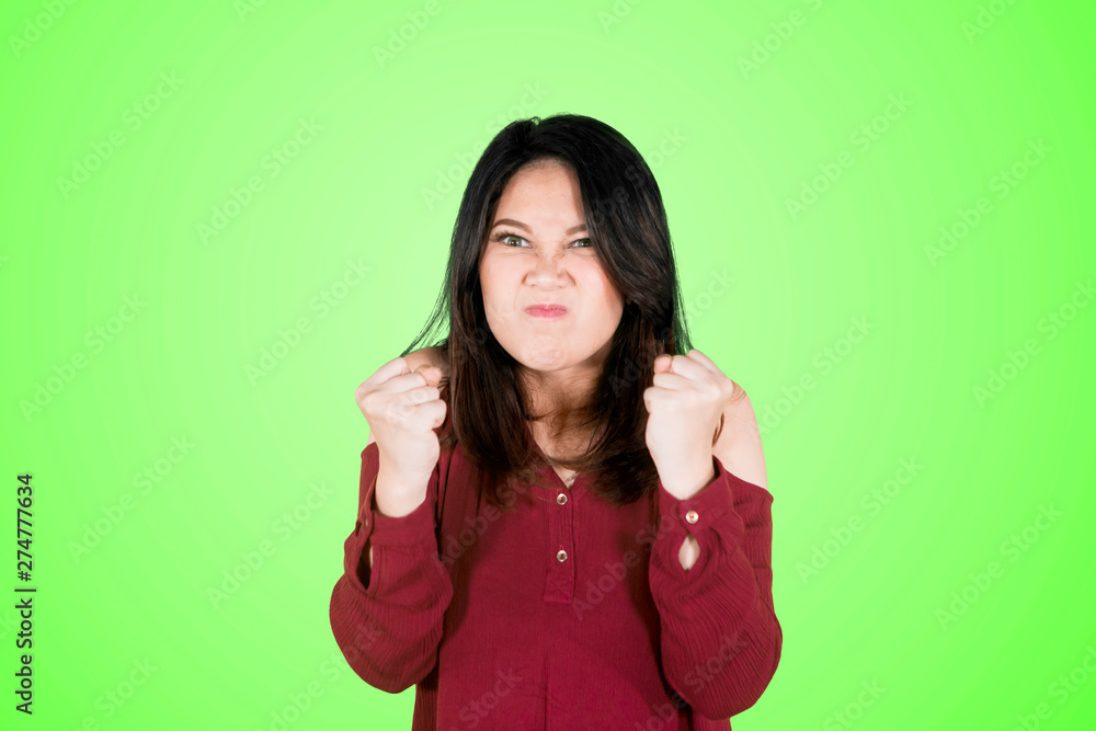 Young woman with furious gesture on studio Young woman with furious gesture on studio