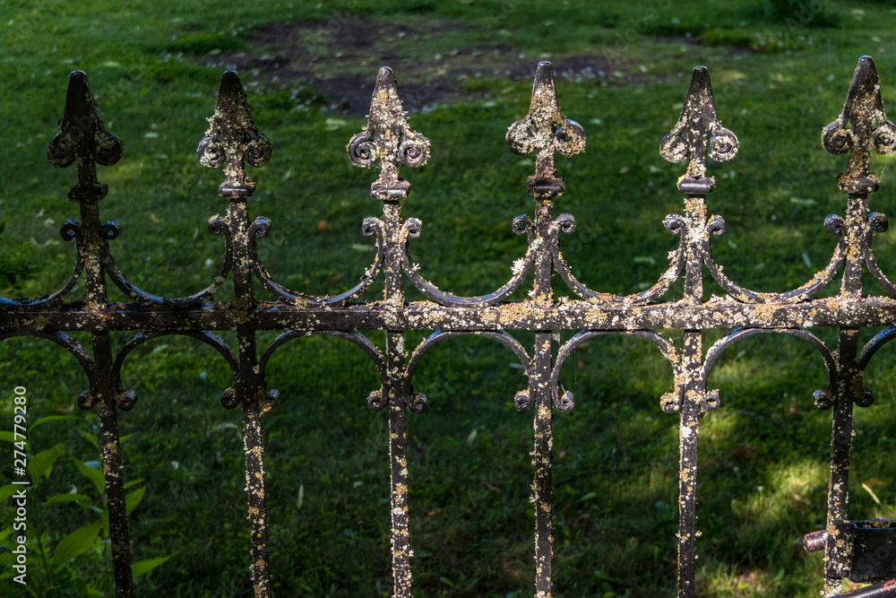 Fototapeta premium Husby, Sweden A moss covered entry gate to a cemetary.