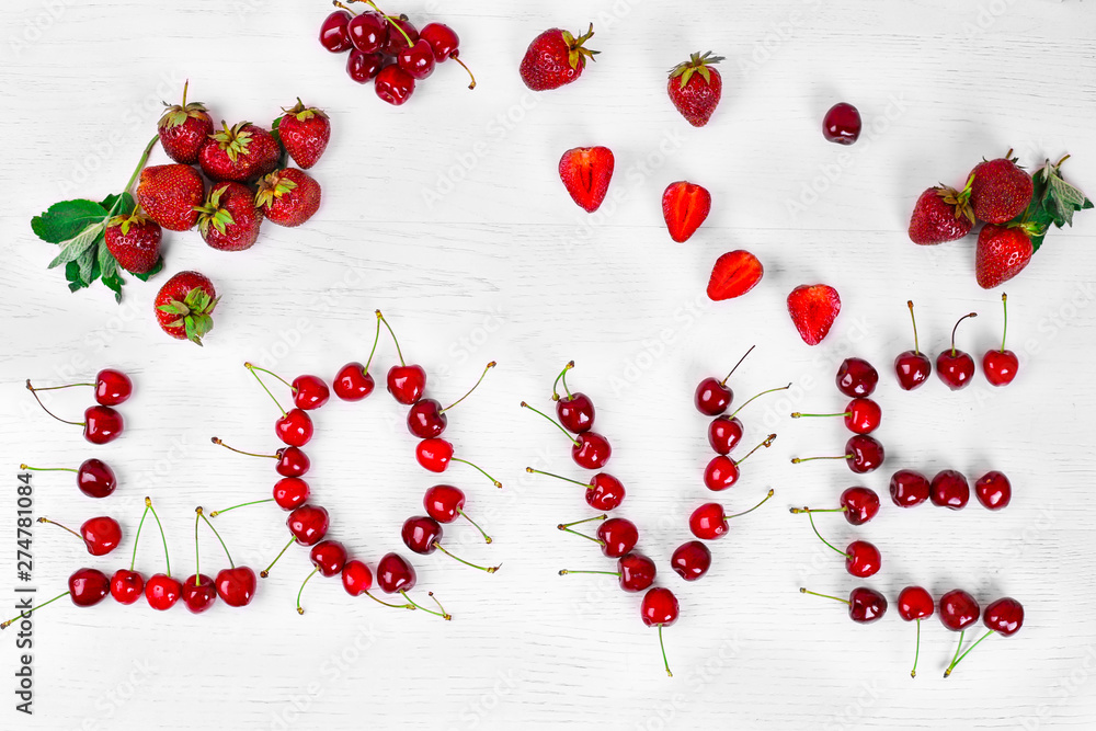 inscription love made of sweet cherry and strawberry on a white background. Beautiful background inscription love made of sweet cherry and strawberry on a white background. Beautiful background