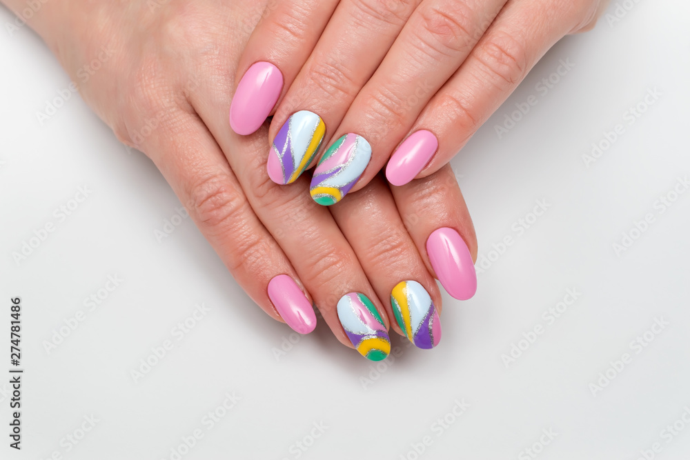 Summer color manicure. pink, lilac, white, yellow, silver manicure on long oval nails on white photo close up Summer color manicure. pink, lilac, white, yellow, silver manicure on long oval nails on white photo close up
