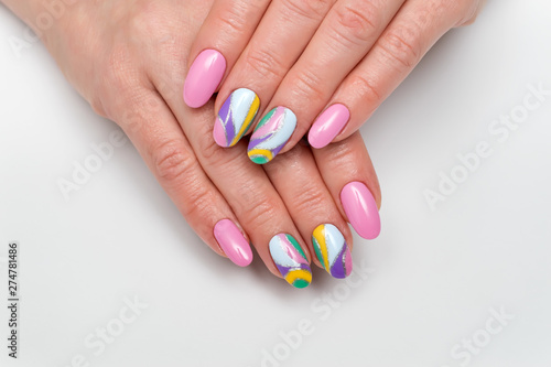Summer color manicure. pink, lilac, white, yellow, silver manicure on long oval nails on white photo close up